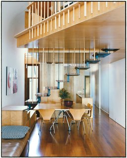 Almost Perfect - Photo 3 of 8 - The addition’s most eye-catching feature is the steel staircase with recycled blackbutt wood treads. The bottom steps double as benches to supplement the six Arne Jacobsen Series 7 dining chairs for Fritz Hansen and a Nomos table base by Sir Norman Foster for Tecno.