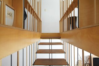 Almost Perfect - Photo 7 of 8 - The steel-and-wood stairs lead to the master bedroom and study.