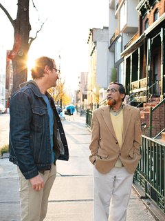 Sherman chats with his neighbor Sakhawat Ullah, the mason who built his front stoop.