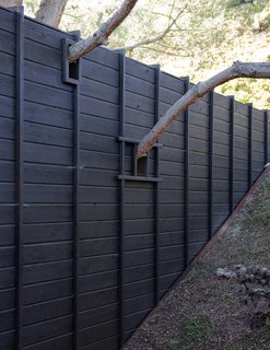 These 11 Modern Fences Bring a Whole New Meaning to Curb Appeal - Photo 2 of 11 - This unique detail imbues the home with a spirit of wabi-sabi—or beauty through imperfection.