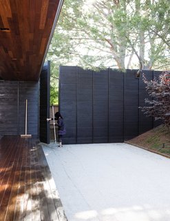 An Atypical Modern Home in Southern California - Photo 15 of 15 - The couple asked for a "no maintenance, not low maintenance" backyard. However, Shino tends to "Carlsbad's largest public bathroom for cats" (otherwise known as their Japanese-style rock garden) about once a month.