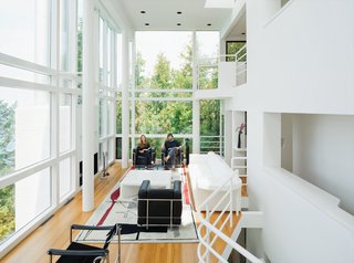 Michael McCarthy and Marcia Myers spent years rehabilitating the Douglas House. The double-height living room features a custom sofa and low table of Meier’s design, and an Edward Fields rug based on a sketch Le Corbusier created in 1956 for a Tokyo theater.