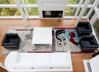 The view overlooking the living room, which features the famous Le Corbusier rug by Edward Fields. The residents were also careful to save the sofa, which Meier himself designed for the space.