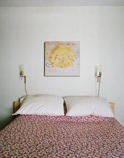 The master bedroom. The coverlet is from Urban Outfitters. The painting is by Helen Rice.