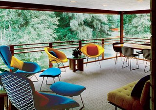 A screened-in porch overlooks the pond and sports furniture by both Harry Bertoia and Dow himself.<br><br>Photo by: Balthazar Korab