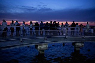 Spectators gather to observe the installation on opening night.