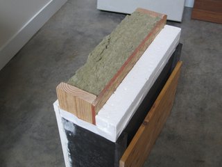 A Zero-Energy Community: Part 2 - Photo 3 of 9 - Our R-38 wall section. Rockwool insulation is placed in the 2x6 cavity, and 3.5 inches of continuous expanded polystyrene insulation is screwed to the outside of the oriented strand board shear wall. A benefit to this exterior insulation is that the thermally conductive bridge of the wood studs is broken by insulation. Even a thin layer of exterior insulation can make a big difference.