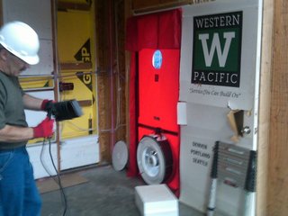 A Zero-Energy Community: Part 2 - Photo 7 of 9 - Performance-testing the home with a blower door and sealing it well is perhaps the lowest hanging fruit in the world of building energy efficiency. The blower door depressurizes the house and helps to find leak points. We sealed our homes to nearly twice what is required by code.