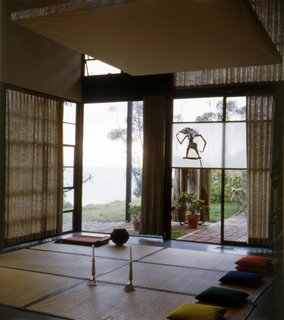 Goza mats and pillows are laid out for seating guests. The ocean can be seen beyond the corner window; it is now more obscured by trees. Photo courtesy the Eames Foundation.
