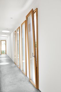 Easy Breezy<br><br>A deft cross-ventilation system keeps things cool in the summer. A series of tilt-turn low-E wood window-doors by Swiss manufacturer Gautschi not only allows passage to the side yard and a bit of extra natural light but, when tilted down, permits breezes to pass through the house.<br><br>gautschi-ag.ch