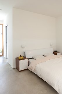 The pattern on the sheets (from Macy's house line) are one of the few breaks from the master bedroom's strong minimalism.