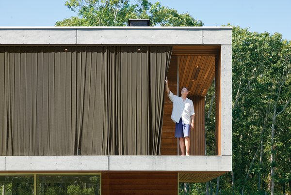Two layers of aluminum woven-coil drapes hang outside the large, south-facing windows above the living area.