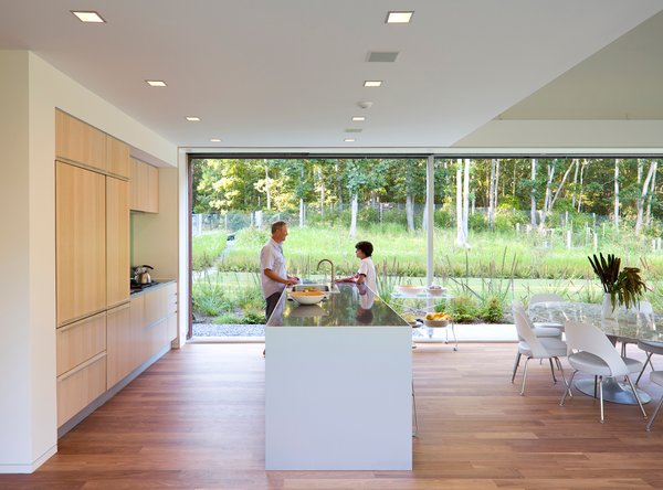 A double-height space encompasses the kitchen, dining and living area, and features 36-feet-wide glass doors that pocket into southern and northern walls.