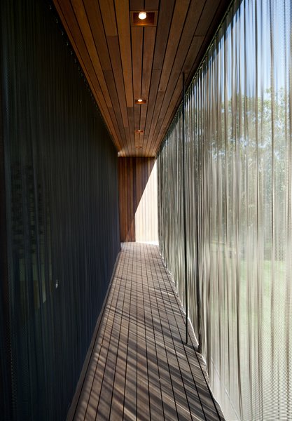 When extended, the metal-mesh curtain wall deflects the sunlight to mitigate the internal temperature of the structure. Similar energy-efficient gestures include geothermal heating and cooling, shading and venting systems, solar panels, and organic finishes and materials.