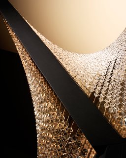 The light comes from four incandescent strips affixed to the frame. Only when open do the grids of crystal take their swooping, parabolic form. <br><br>Don't miss a word of Dwell! Download our FREE app from iTunes, friend us on Facebook, or follow us on Twitter!