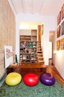 More custom bookshelves in an upstairs sitting room, cleverly inserted into the villa's extant niches.