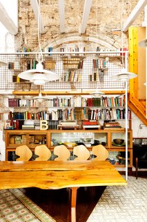 Tagliabue made sense of the soaring volume in the library by installing double-height custom bookcases that can be accessed via a catwalk.
