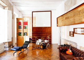 Sliding panels of Tagliabue's design delineate space in the first-floor sitting room, which opens to an office.