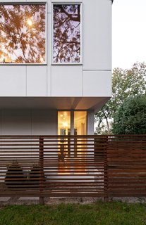 The cedar screen that extends out from the dining and living rooms traces the line of the actual setback and reads not as a wall of the house but as a delineator of exterior space. The same material is used on the railing on the roof deck and offers a bit of privacy without, according to Braver, "looking like a stockade."