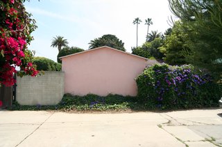 The back of the property as seen from the rear alley. The pink colored structure is an existing single car garage which will be deconstructed at the same time as the cottage.