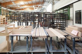 Ruché Sofa - Photo 3 of 11 - When an order comes in, workers feed the wood into a high-tech preprogrammed machine that mills it into ten square-sided posts and drills holes where the pieces will connect.