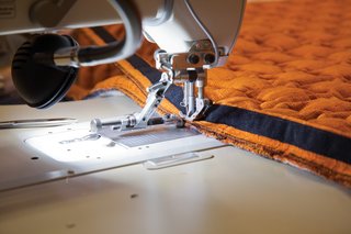 Ruché Sofa - Photo 9 of 11 - Sewers stitch zippers on to the cover’s edges to enable it to attach securely to the wooden sofa frame.