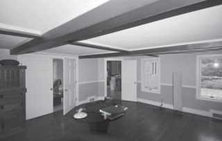 New McDonald - Photo 3 of 5 - Trim Beam<br><br>"The most difficult part of combining the living and dining rooms was that the ‘fake’ Colonial ceiling beams in the dining space"—which took the already-low seven-foot ceilings down to a head-scraping six feet four inches—"turned out to be structural," says Bardt. Working with an engineer, he and Leski "shaved down" the beams and reinforced them to achieve a uniform ceiling height "without tearing the house apart."