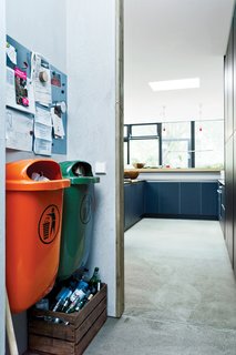 Bring In the TrashWith an eye for the industrial, Winterhalder built the garbage area in the kitchen around two standard-issue plastic trash cans common in German cities. One is orange; the other, green. These in turn inspired her to start adding color accents around the house.