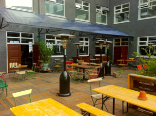 Kex Hostel, Reykjavik - Photo 8 of 9 - Shielded from the Atlantic wind, this cozy patio is a popular hangout for visitors and locals alike.