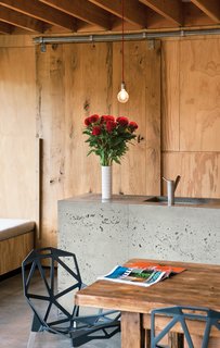 Island LifeThe appealing, handcrafted appearance of the concrete kitchen island is a happy accident, the result of the concrete not settling fully in its timber framing. When the framing was removed, the builder, Peter Davidson, was worried that Davor and Abbe would be disappointed with the bubbled result and offered to start the process again, but they loved its one-off feeling and persuaded him to keep it that way.