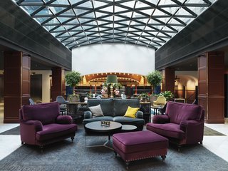 The Scandic Grand Central, Stockholm - Photo 2 of 12 - The hotel is in a building that dates from 1885. Here's the lobby, which is outfitted with comfortable couches and Eames/Saarinen Organic chairs (you can make out a couple of the chartreuse and grey beauts in the background).