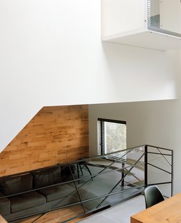 The kitchen overlooks the sunken living room, beneath the master bedroom.