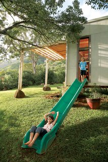 Jackson and Zeke escape their bedroom through a slide repurposed from an old play structure. The 20-acre property backs up to nearby mountains.