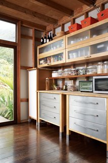 Swede MotionWith no Ikea in Hawaii, the Gambys took advantage of a trip to Los Angeles during construction to pick up their kitchen cabinets—simple models made of glass, plywood, and particleboard. They shipped the cabinets to the island and, à la all things Ikea, put them together onsite, situating them high above the counter.<br><br>ikea.com