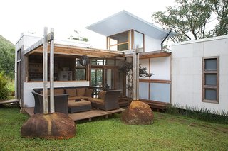 The back patio is bordered by boulders picked up on the Gambys' land. Tanya says that particular design element will be repeated in the next home they build: "We've actually unearthed one the size of a minivan that we're going to use in the bigger house."