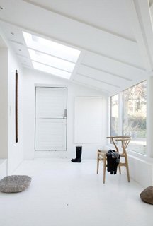 The skylight over the home’s entrance "helps simulate a feeling of grandeur and creates an airy and welcoming atmosphere," says Bjerre-Poulsen.
