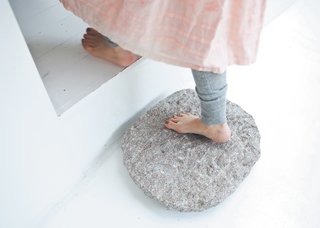 The stepping stone, like the skylight, was inspired by zen architecture. "In most traditional wooden houses and temples in Japan, the house is lifted above the garden, and the transition is always marked by a sculptural stepping stone," says Bjerre-Poulsen. "We used the same principle between the old house and the addition."
