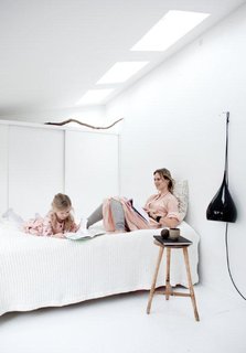 Maja and Asa hang out in the guestroom, which also doubles as storage space with an entire wall of closets along one end.