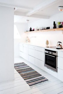 Another view of the kitchen. What looks like drawers are not all drawers—some are false cabinet fronts that conceal appliances.