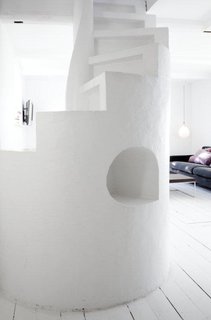 The sculptural staircase is a centerpiece of the open-plan kitchen and living room.
