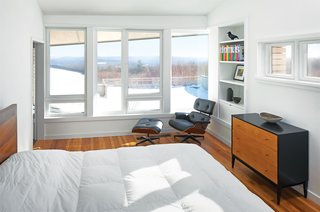 Modern Courtyard House with Custom Rain Screen - Photo 1 of 3 - An Eames lounge and ottoman hold court in the master bedroom upstairs. Plenty of natural light and a muted color scheme give the space a wonderfully light feel.