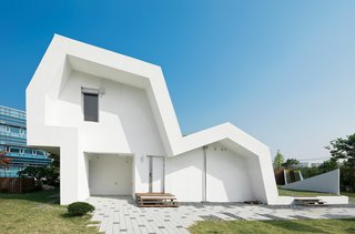 Modern Green Concept House in South Korea - Photo 2 of 10 - RoofreaderThough they may look like architecture school run amok, the steep pitches and cants of the roof have everything to do with the home’s ecological agenda. By creating a series of green roofs, maximizing daylighting and water catchment, and optimizing the positions of light tubes and building-integrated photovoltaic panels, the roof is a canny mix of passive solar design and state-of-the-art technology.