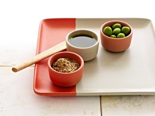 A two-tone tray in Poppy-dipped Birch is the perfect backdrop for a trio of condiment bowls in poppy, birch, and grapefruit.