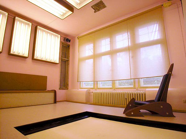 Propeller Island Hotel, Berlin - Photo 8 of 9 - This minimal space conveniently doubles as a photographer’s studio with in suite backdrops and lighting boxes. Obviously, the bed is located under the floor beneath a garage gate.