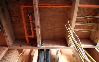The orange CPVC pipes are for fire sprinklers. Since January 1st, 2011, fire sprinklers have been required in all new homes in California, adding a significant line item to the construction budget for a home.