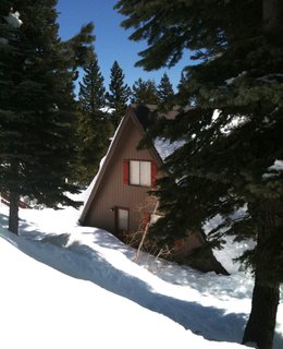 The A-frame here looks both rustic and modern, especially with its orange shutters.
