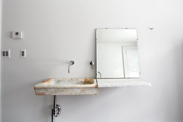 Hope Floats - Photo 10 of 12 - In the guest bathroom, Givone installed a hand-chiseled sink made of 17th-century marble quarried from the hills outside of Rome.