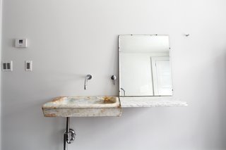 In the guest bathroom, Givone installed a hand-chiseled sink made of 17th-century marble quarried from the hills outside of Rome.
