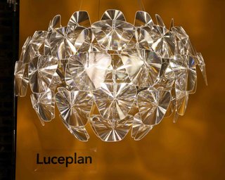 Incredibly light but painstaking to assemble, Luceplan's Hope light proved to be worth every second, illuminating the room, and drawing many oohs and aahs as guests stared into the reflective plastic. A series of thin polycarbonate Fresnel lenses, created using imprinted microprisms on polycarbonate film to achieve a dioptric effect similar to glass,multiply the light from the light source, recreating a pleasant, glittery and party-like atmosphere. Hope – the fruit of a brilliant project and manufacturing process – has been designed for use with any type of light source and showed off the Pharox bulbs.