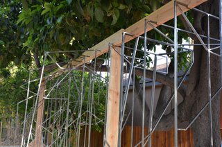 The profiles are numbered and notched on the wood jig, which holds them in place and ready for the in-between steel pieces.